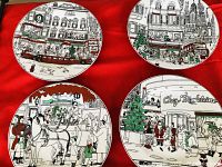 Four Epoch Paris Christmas-themed appetizer or lunch plates laid on red fabric, detailed Paris street scenes with Christmas decorations and people depicted in mostly black, white, green, and red colors.