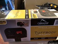 Box showing Gibraltar Tuffbody Premium Series Mailbox in black heavy gauge steel, vandal resistant, standard capacity.