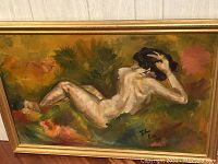 Framed oil painting showing reclining nude woman in a colorful naturalistic setting. Signed and dated by artist John Eisd 1967.
