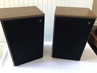 Pair of vintage Acoustic Research AR 18 speakers with wood grain cabinets and black grille covers.