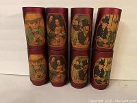 Two sets of four red cups each displayed with famous artwork reproductions on them including images of people in classical painting style.
