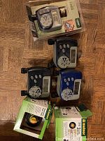 Six outdoor water timers, including four unboxed digital models with dials and two boxed Medcome and Koop brand timers.