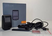 Apeman C370 dash camera shown with original box, USB car charger cable, and mounting accessories.