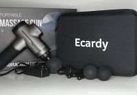 View of the metallic gray Ecardy massage gun alongside a carrying case, four massage heads, and power cord.