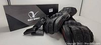 Photo of Day Wolf rechargeable heated motorcycle gloves with battery pack and original box visible.