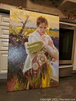 Full view of painting leaning against kitchen backsplash