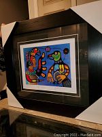 Framed and matted print showing the full artwork "Eagle Dancer" by Paul Kohoko with protective corner covers on frame.