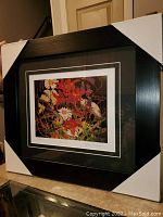 Full view of professionally framed and matted "Flowers" fine art print by Tom Thomson with protective corner guards on frame.