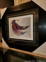 Full view of the professionally framed and matted fine art print "Native Celebration" depicting a colorful bird-native figure.