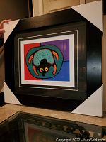 Overall photo showing the professionally framed art print with protective corner additions on the frame.