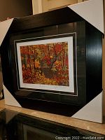 Image of the professionally framed and matted print showing vibrant autumn foliage and a water body.