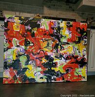 Front view of the oil painting showing full abstract composition of red, black, yellow, green, purple brushstrokes