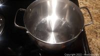 Top-down view showing the inside of stainless steel pot with visible use marks.