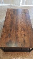 Top down view showing wood grain finish tabletop with natural knots and color variation.