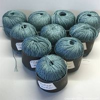 Photo showing 10 unopened balls of teal/blue grey yarn arranged in two rows.
