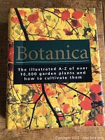 Cover of 'Botanica' garden book with colorful autumn leaves, title, and subtitle describing coverage of over 10,000 garden plants and cultivation advice.