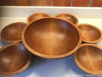 Top view of all bowls together showing one large bowl in the center surrounded by six smaller bowls.