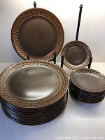 Full set of stacked dinner and dessert plates with display stands