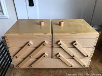 Wide angle showing three layered hinged structure with wooden swivel arms fully closed, top view.