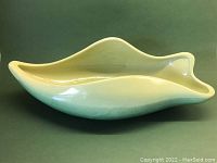 Front angle view showing the full length and wave-like shape of the BEAUCEWARE ceramic vessel in gradient pale to dark green.