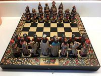 Full view of the chess set on the chessboard, showing all pieces in starting positions with Spanish Conquistadors facing Aztecs.