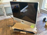 Front view of 24-inch Apple iMac all-in-one computer on wooden table