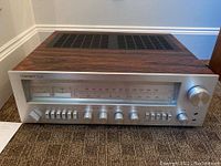 Front view showing faceplate, tuning scale, dual meters and control layout