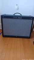 Front view of amplifier showing Fender Deluxe badge, black Tolex and silver grille cloth