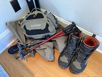 Waders, boots, Sage bag and Black Diamond sticks leaning in corner