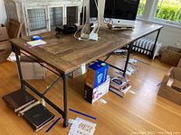 Side view of reclaimed wood tabletop and black metal pipe frame with caster wheels