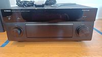 Front view of receiver with power and volume knobs, display, Yamaha and Aventage logos visible