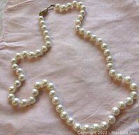 Full view of 18-inch strand of uniform round pearls with clasp