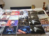 20 Beatles vinyl records laid out showing album covers from Beatles group and solo Beatles members including John Lennon, George Harrison, and Paul McCartney.