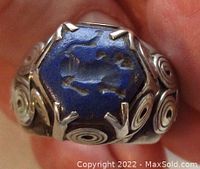 Front view showing hexagon carved lapis lazuli intaglio with feline animal and claw prong setting.