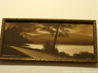 Full view of the framed gouache painting showing Stanley Park landscape with trees, water, and moody sky in dark sepia tones.
