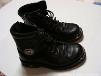 Side profile view of the black Harley Davidson boots showing emblem and steel toe caps.