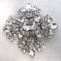 Front close-up view of the vintage Sherman brooch showing the clear crystal stones set in a Maltese cross design.