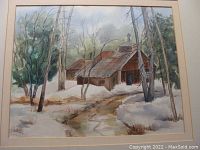 Full front photo of the framed watercolor painting showing the cabin and snow landscape.