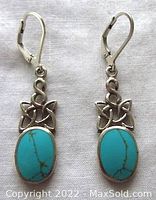 Front view of both sterling silver Celtic turquoise earrings showing turquoise oval cabs and Celtic knot design.