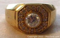 Top view showing bezel-set center stone and surrounding small stones