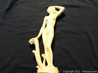 Front and side view of the vintage nude female alabaster sculpture showing natural patina and detailed carving.