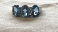 Front view of ring showing three oval blue topaz stones set in sterling silver.