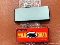 Red Wild Boar knife box and rectangular knife sharpener in original plastic packaging.