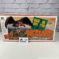 Front of the game box shows colorful vintage Milton Bradley game artwork featuring a large buzzard and characters, with the title 'Back Off Buzzard.'