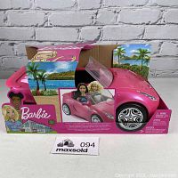 Front view of pink Barbie convertible car in original box with two dolls seated inside, box decorated with tropical background.