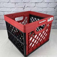 Front and side view of a red and black collapsible milk crate with the CleverMade logo visible.