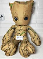 Front view of the Groot plush showing the wood texture and facial details.
