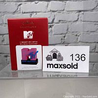 Photo of the boxed MTV musical Christmas tree ornament by Hallmark with MaxSold lot number.