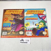 Front view of two Nintendo Power magazines, volume 36 and 37, showing cover art featuring Darkwing Duck and Lemmings respectively.