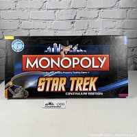 Closed box of Star Trek Monopoly Continuum Edition showing front graphic with Monopoly mascot and Star Trek text